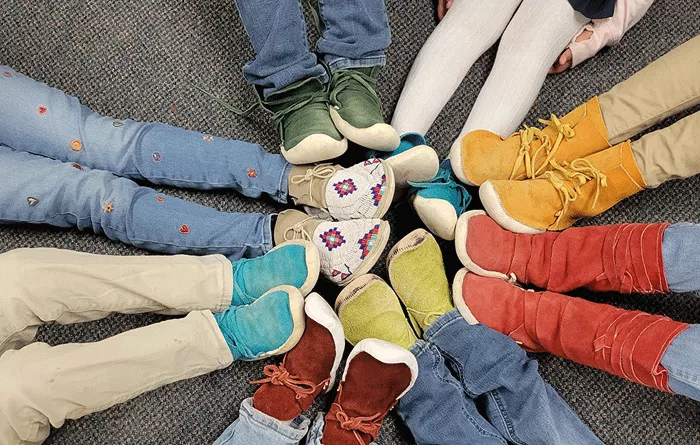 Shoes of little kids in a circle.